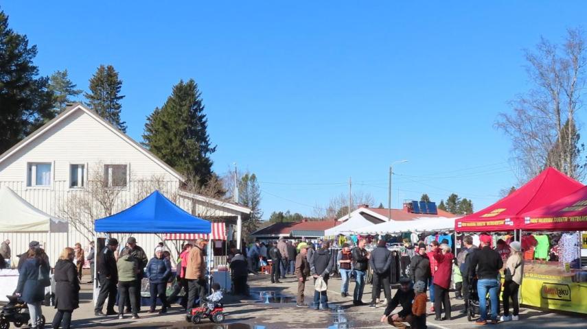 Kuva markkinoilta. Markkinakojuja ja ihmisiä.